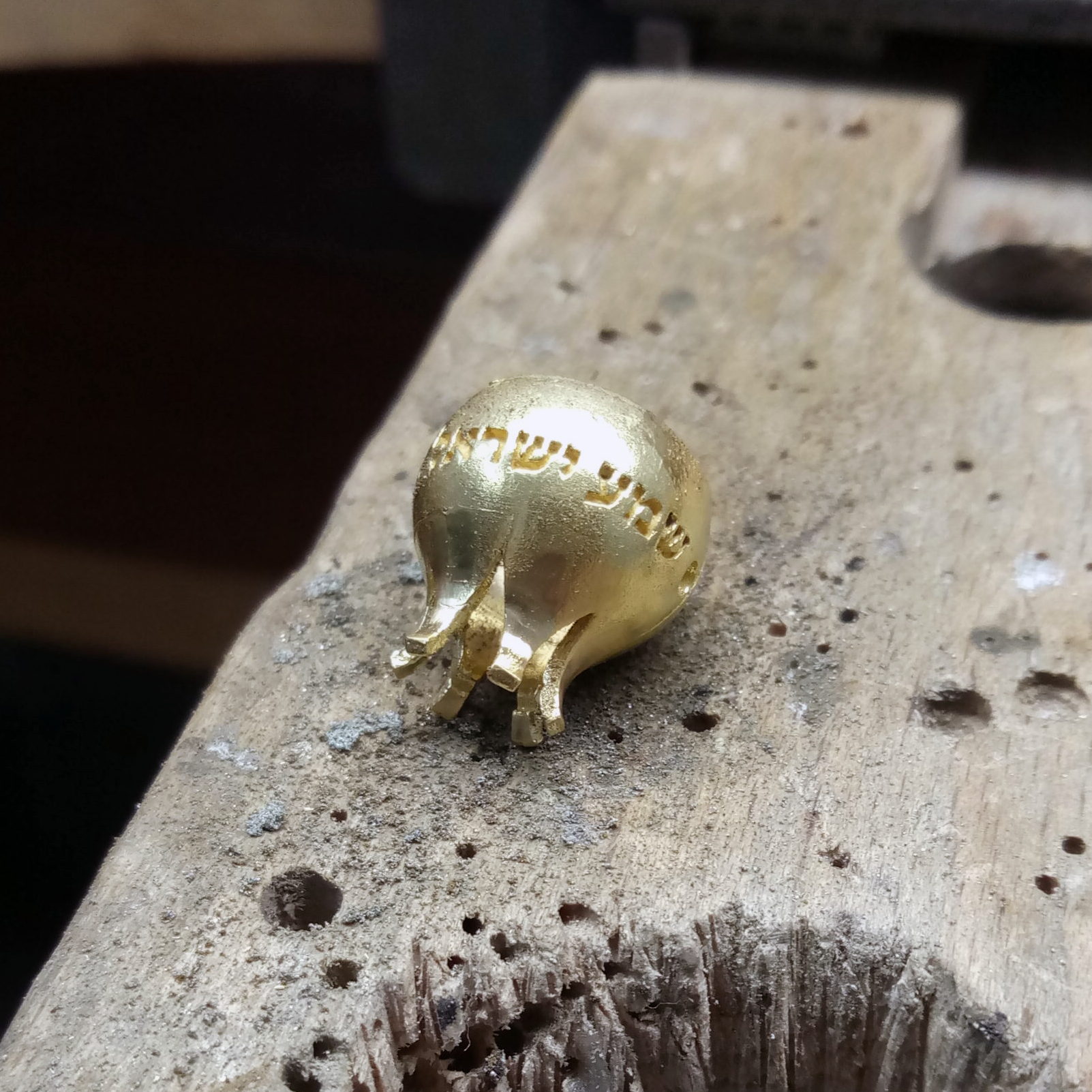 Assembling the pomegranate halves and hooks at the bench